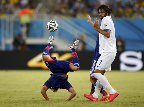 japans-atsuto-uchida-does-a-handstand-during-a-game-against-greece