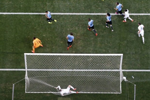 wayne-rooney-gets-caught-in-the-net-after-missing-a-shot-against-uruguay